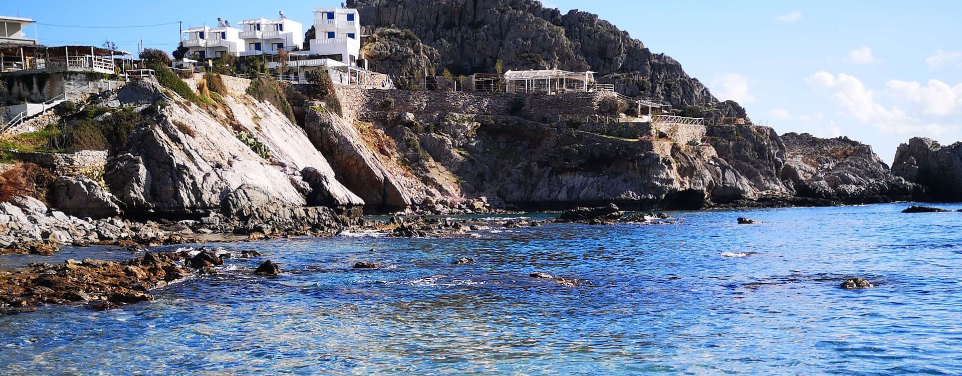 Yoga Rocks retreats from the clear sea at Agios Pavlos