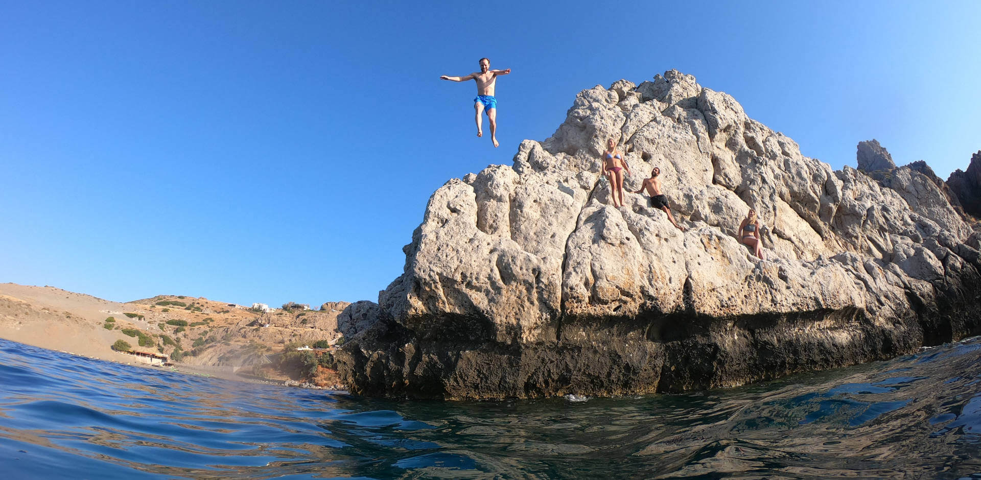 Rock jumping into pristine seas just by Yoga Rocks retreat Crete