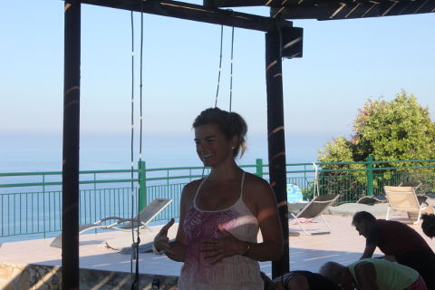Coral Brown smiling on yoga deck in Crete