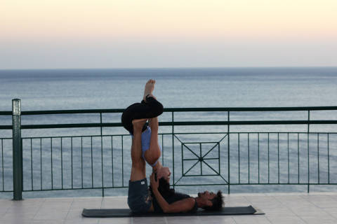 Flying badha konasana on the terrace at Yoga Rocks