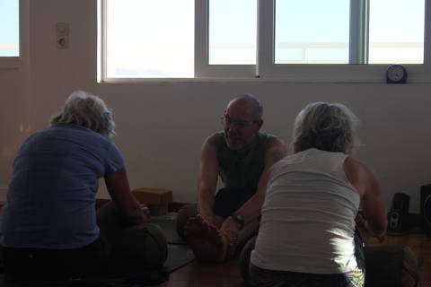 Forward bend in yin yoga class with Norman Blair