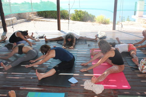 Upavista konasana on yoga with sea view, Crete