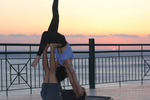 Therapeutic acro yoga at sunset