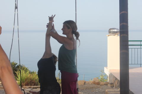 Coral Brown adjusts utthita parsva konasana at Yoga Rocks