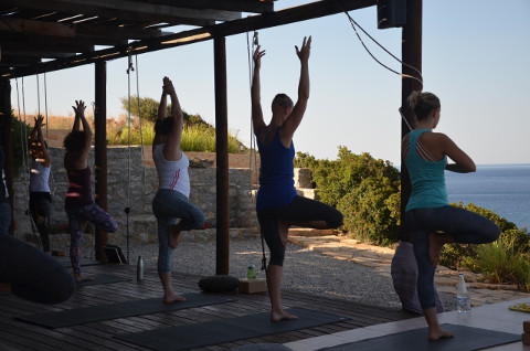 Vrksasana on yoga retreat deck in Crete