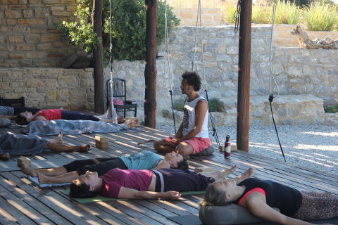 Corpse pose on yoga holiday in Greece