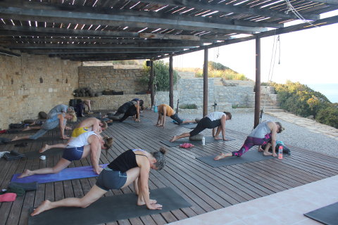 Relaxed lunge on the deck on yoga retreat