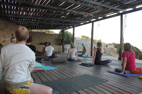 Simple seated twist in outdoor yoga class