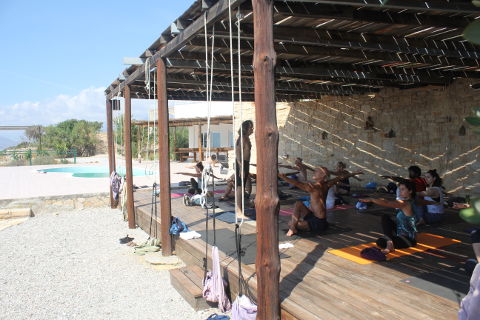 Egyption shoulder openers on the deck on yoga retreat with Danny Paradise