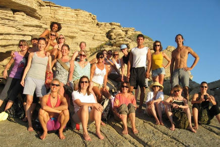 David Lurey and a group of happy yogis on retreat near Yoga Rocks on the rocks at Triopetra