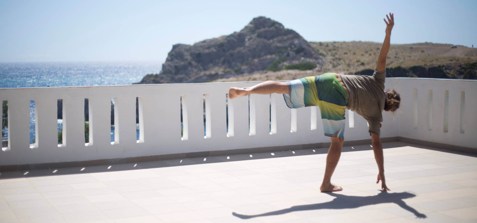 Ardha chandrasana or half moon on the terrace at Yoga Rocks Crete