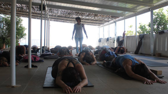 One legged king pigeon pose on the yoga terrace at Yoga Rocks Crete