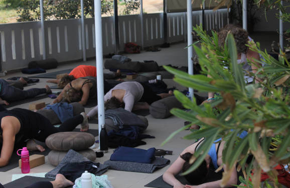 One leg royal king pigeon pose with Josis Sykes on the terrace at Yoga rocks Crete