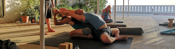 Patner baddha konasana in Friday afternoon partner yoga class