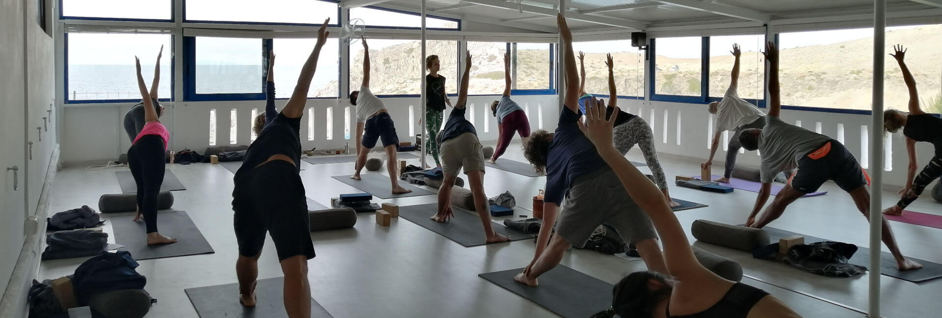 Fleur teaching extended trangle pose in Yoga Rocks shala