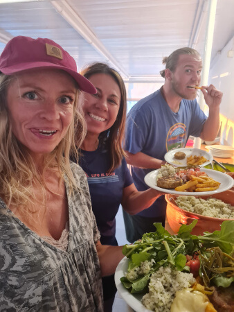 Juicy vegan burger and chips on Yoga rocks buffet with happy retreaters