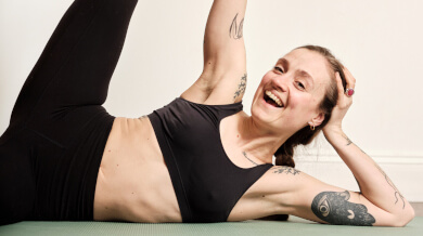 Rachel Walsh in reclining asana coming to Yoga Rocks