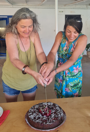 Daniella and Sarah-Jane cut the cake